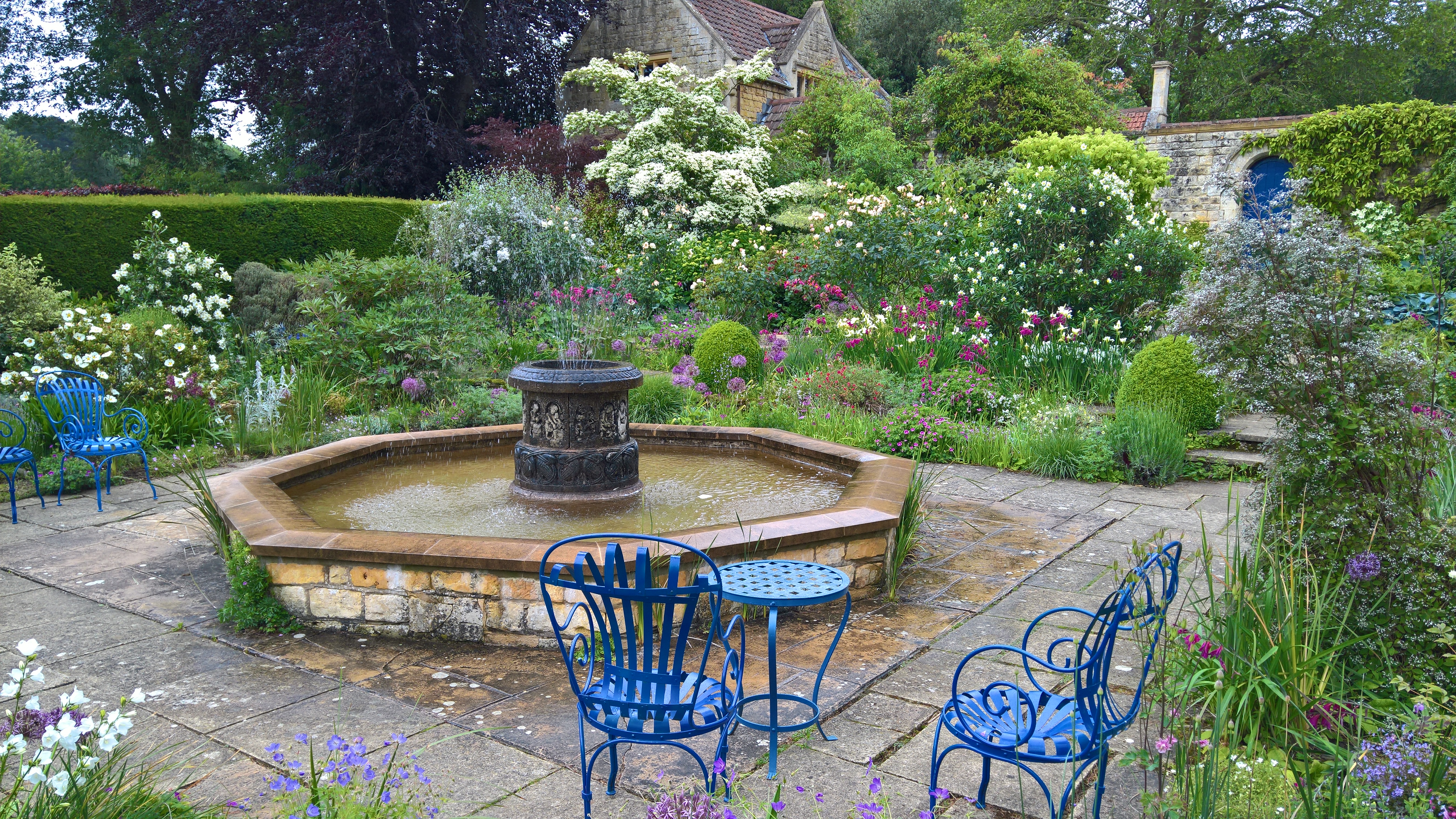 white garden with blue chairs