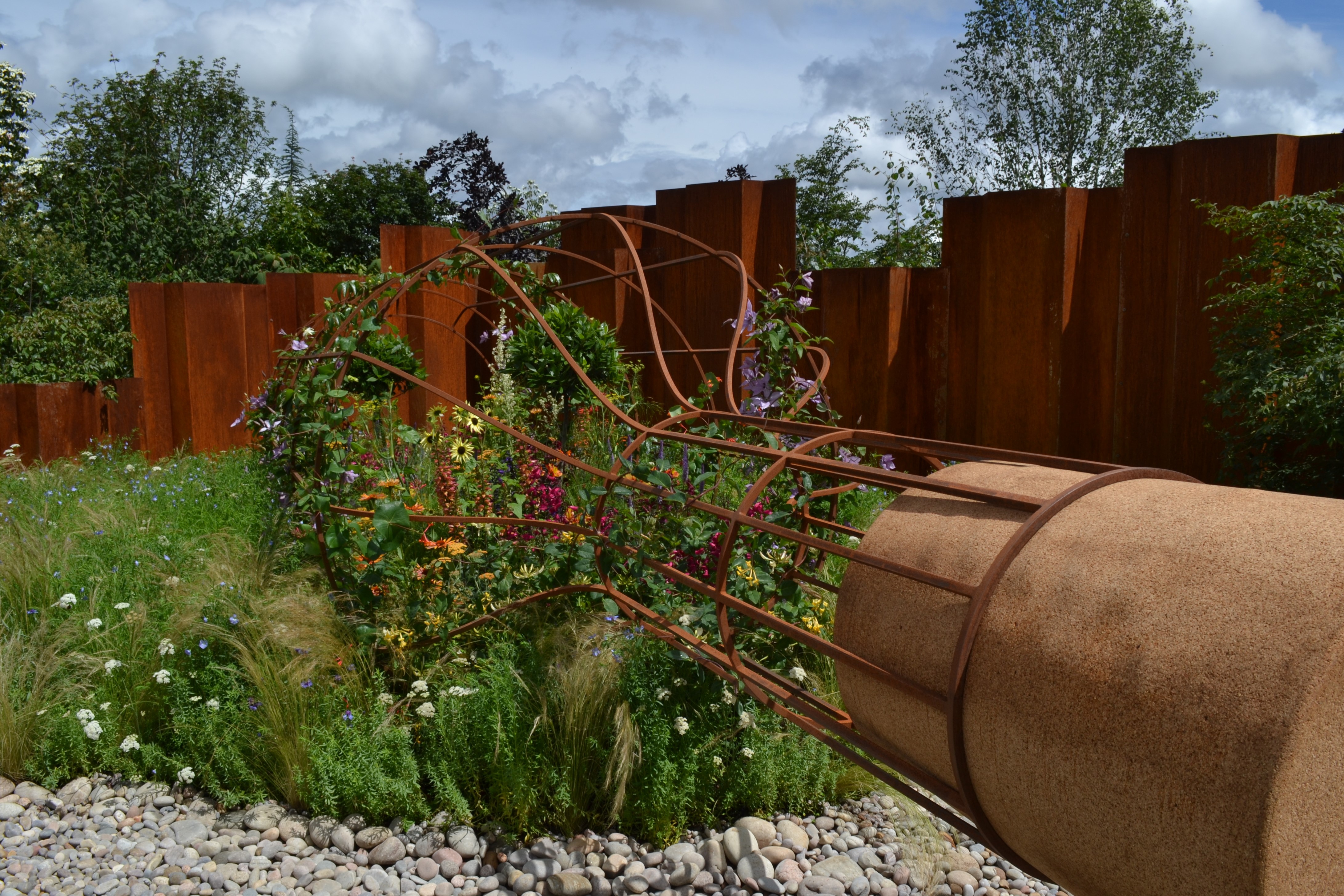 giant metal bottle with a garden inside